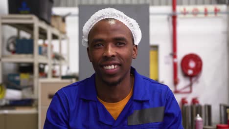 Warehouse-worker-smiling-and-looking-at-camera