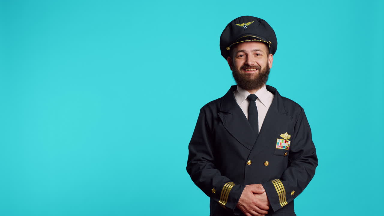 Male plane captain wearing airline uniform and posing
