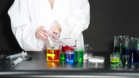 scientist conducting experiment with colorful liquids