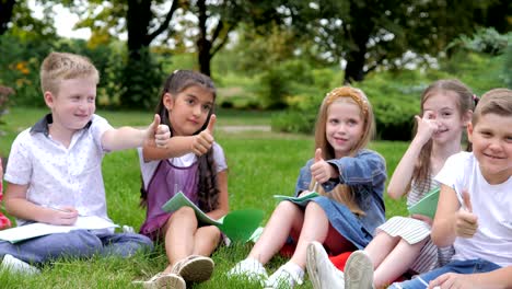 group of cheerful children learning outdoors at school after quarantine lockdown