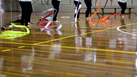 ladies doing choreography and moving rhythmic gymnastics colorful tapes