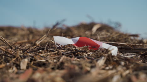 Red-and-white-striped-tape-marking-a-pre-construction-terrain---Close-up