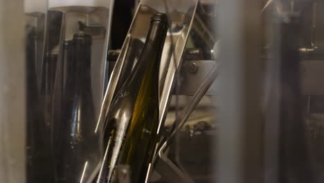 machine cleaning wine bottles before they get filled; bottling process
