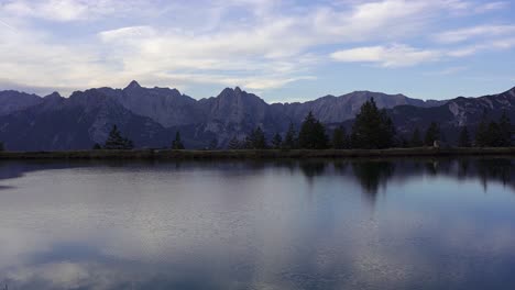 Panning-shot-of-Kaltwassersee,-a-perfect-alpine-lake-with-mountain-reflections-near-Seefeld-in-Tyrol-in-Austria