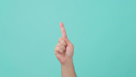 close up shot of human hand raising with index finger or forefinger swipes from left to right multiple times. the man showing hand gesture shaking his balm hand in isolate blue screen in background.