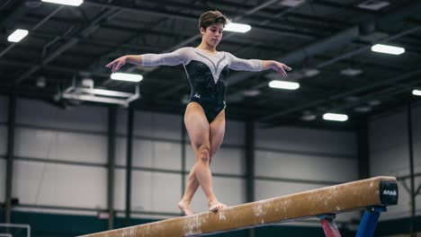 a gymnast's graceful performance on the balance beam, showcasing precision and elegance in competitive gymnastics