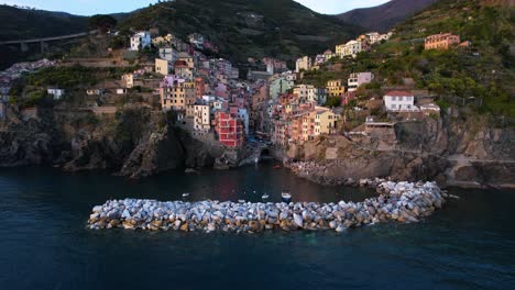 aerial shows colorful facades of houses on terraced hillside