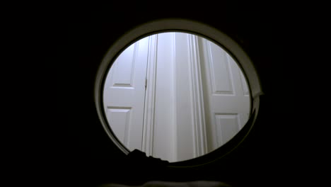 putting dirty laundry into front load washing machine in the house - view from the inside - close up