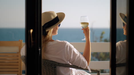 woman relaxing in solitude she drinking wine and enjoying sea view