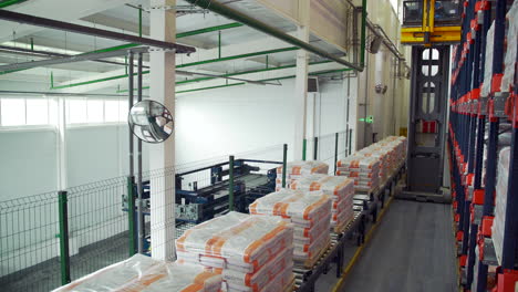 automated warehouse with forklift and conveyor belt