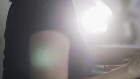 Female-working-on-phone-and-laptop-in-home