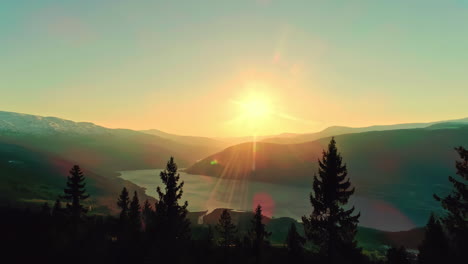 Sunset-Sky-Aerial-Landscape-trees-mountain-forest,-lake-reflected-inside-valley