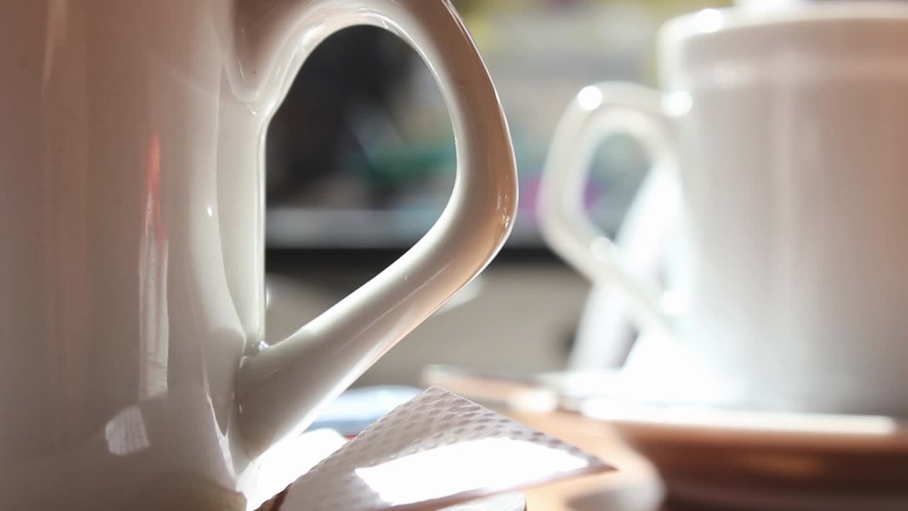 White Ceramic Cups on a Table in Bright Sunlight