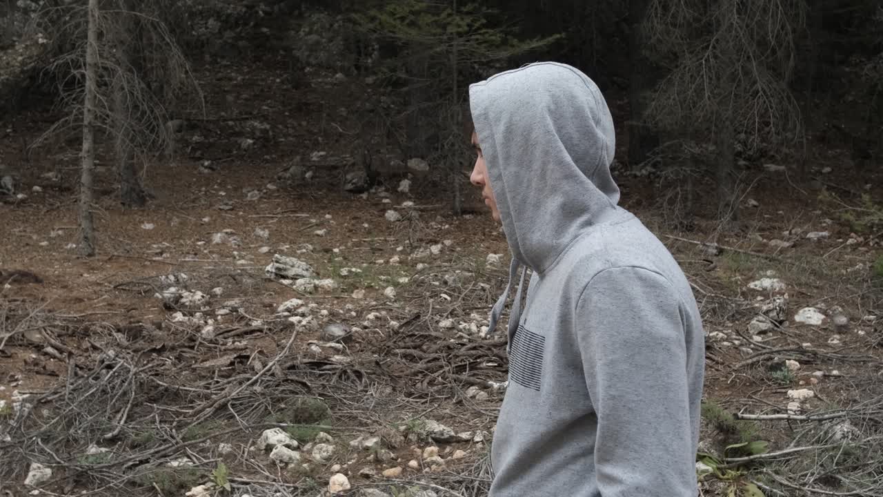 Hooded man hiking