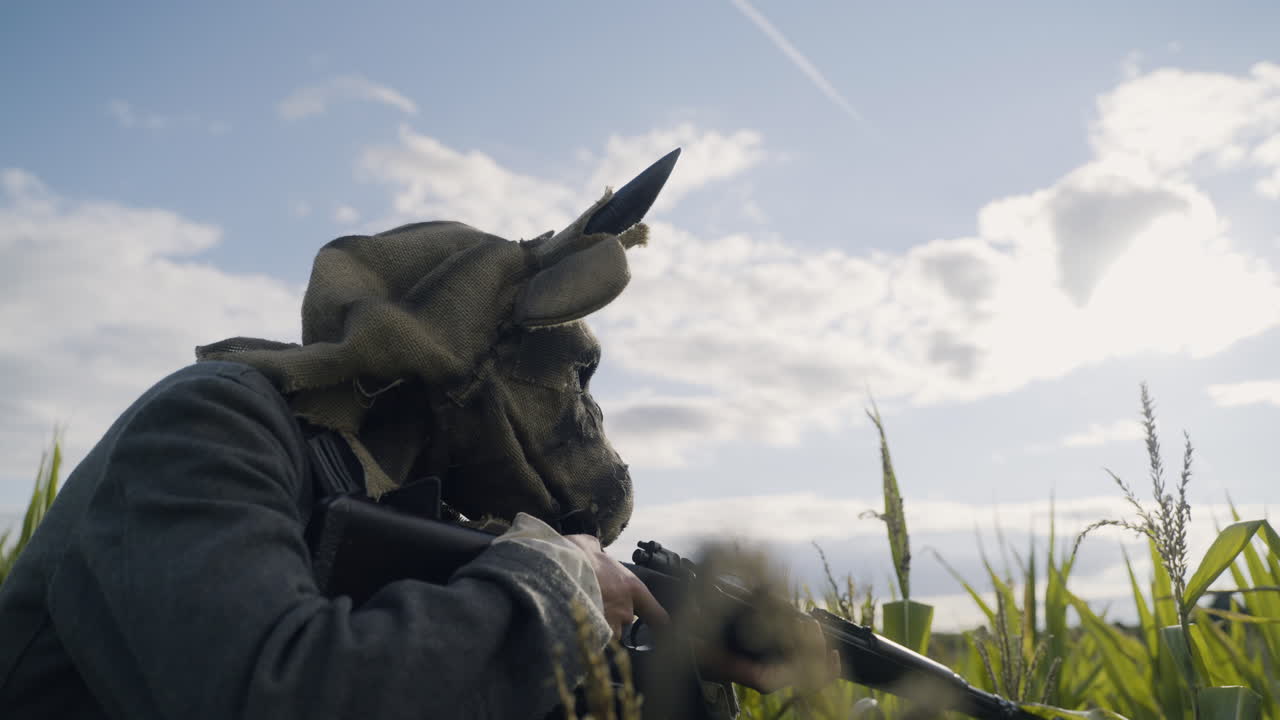 Soldier with Animal Mask in Cornfield