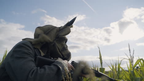 soldier with animal mask in cornfield