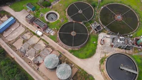 Aerial-view-of-farm-with-tank-for-food-storage-in-a-remote-rural-area-with-green-meadow-vegetation