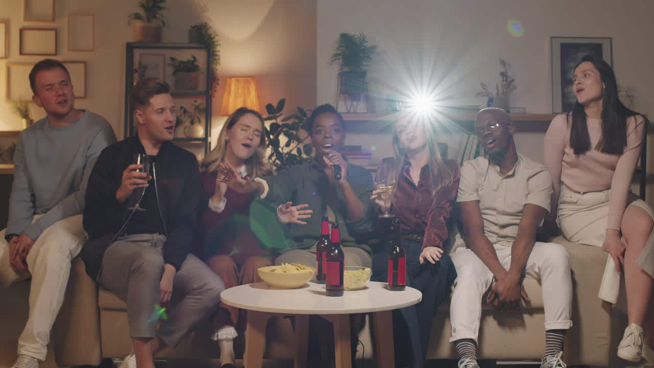 Young People Singing Karaoke at House Party