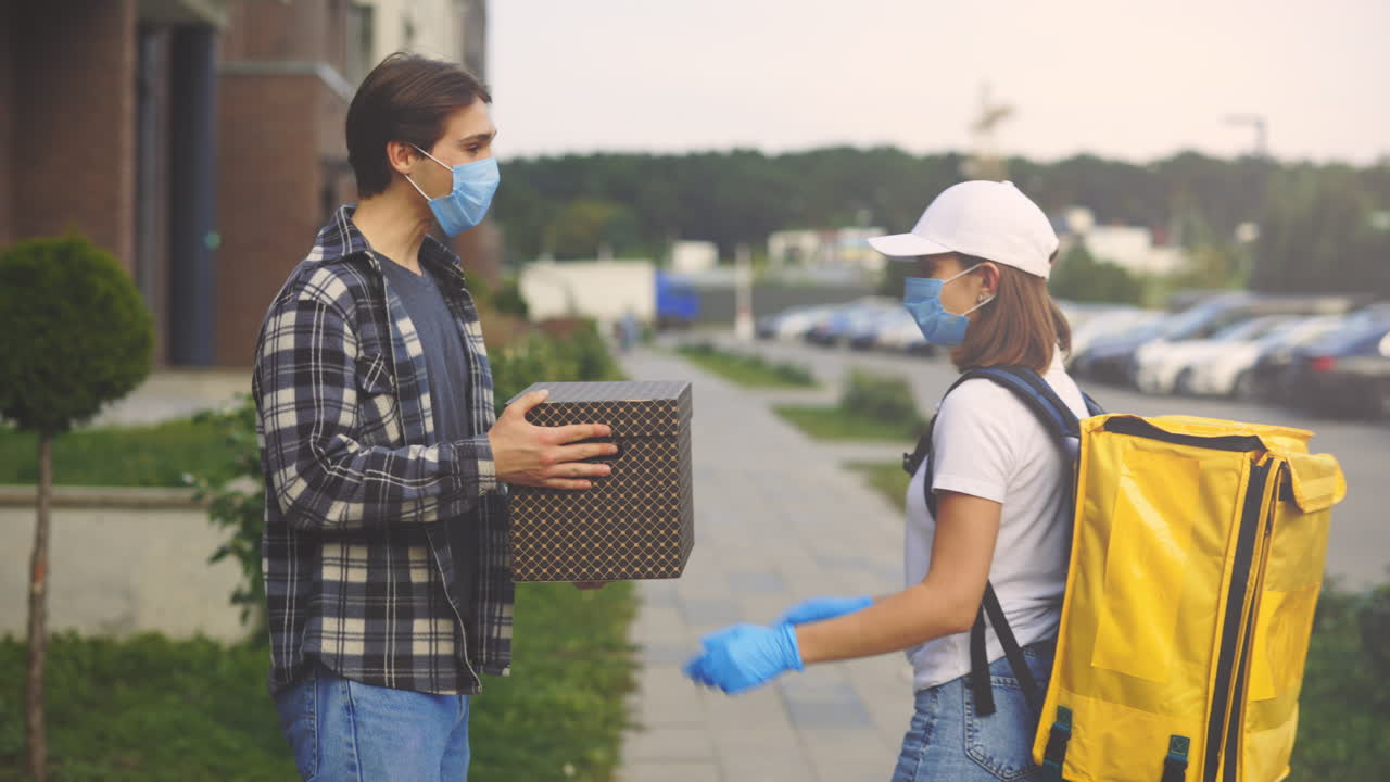 Delivery Person and Recipient Exchange Package During COVID-19 Pandemic