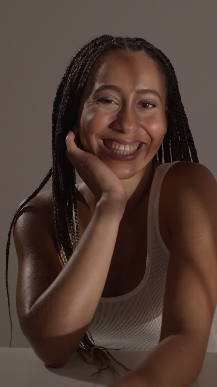Studio Beauty Shot Of Young Woman With Long Braided Hair Sitting At Table 3