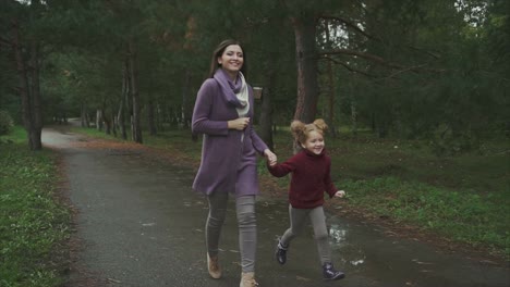 mother and daughter enjoying a rainy day in the park