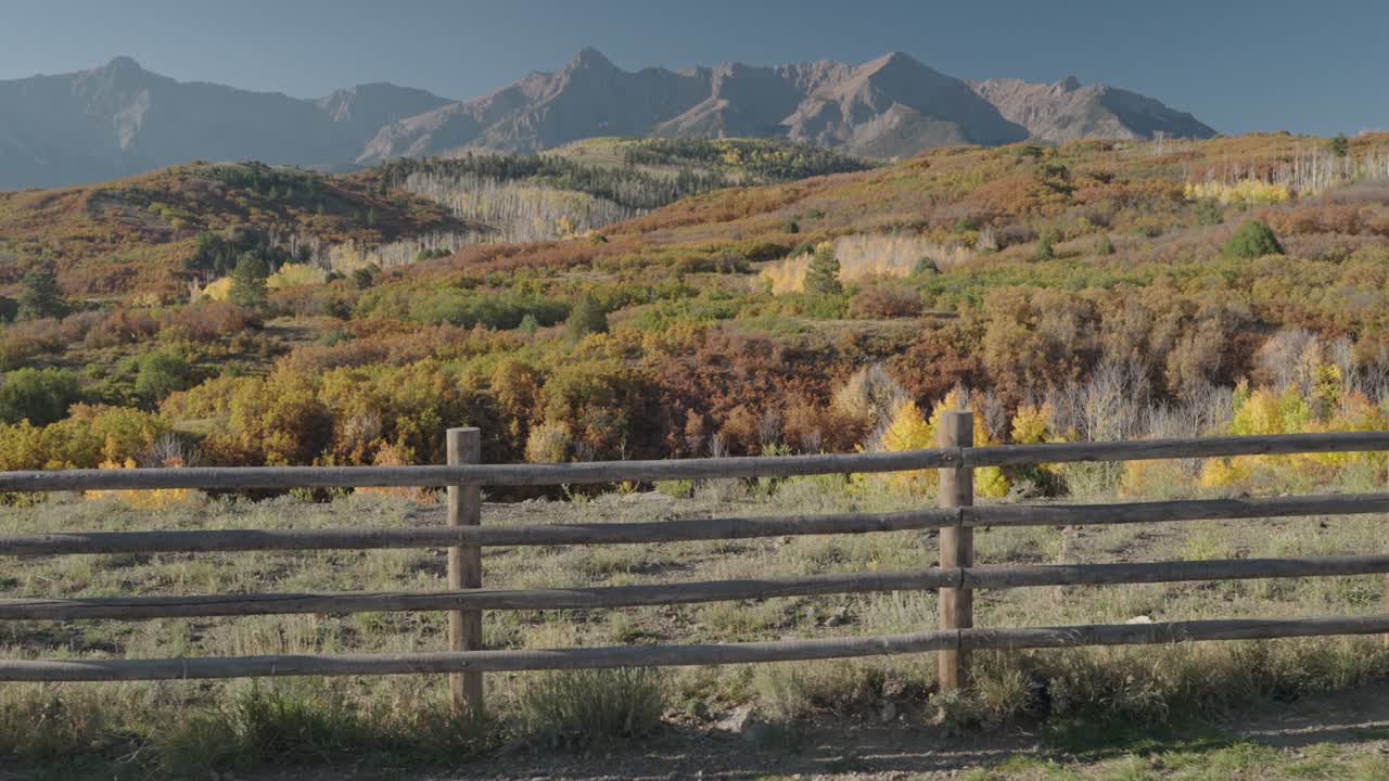 Scenic Autumn Landscape with Mountains and Fence