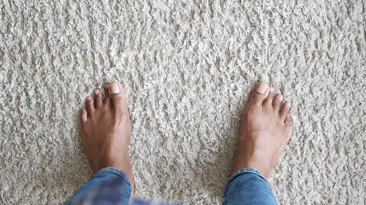 Barefoot Person Standing on Carpet