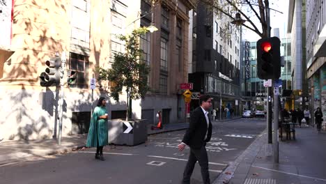 people crossing street at traffic light