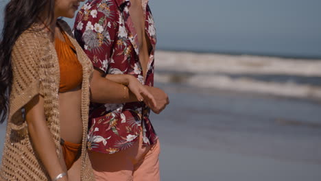 cute couple walking on the beach