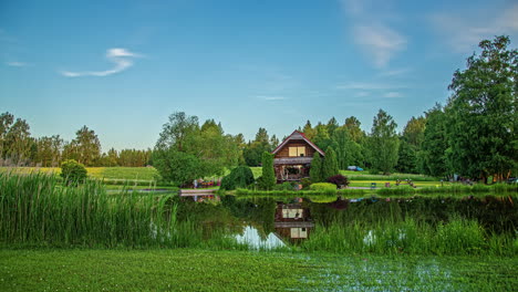 day to night timelapse of wooden cabin around lush green landscape