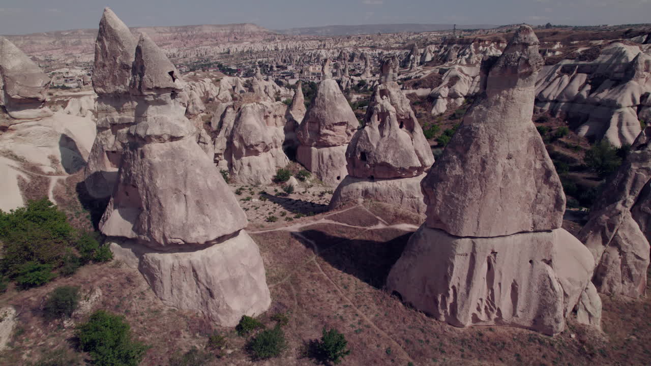 Close aerial view of Cappadocia's iconic fairy chimneys and rocky terrain