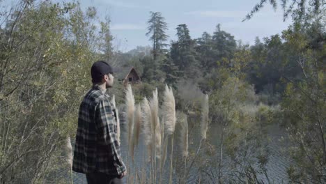 man looks over beautiful lake