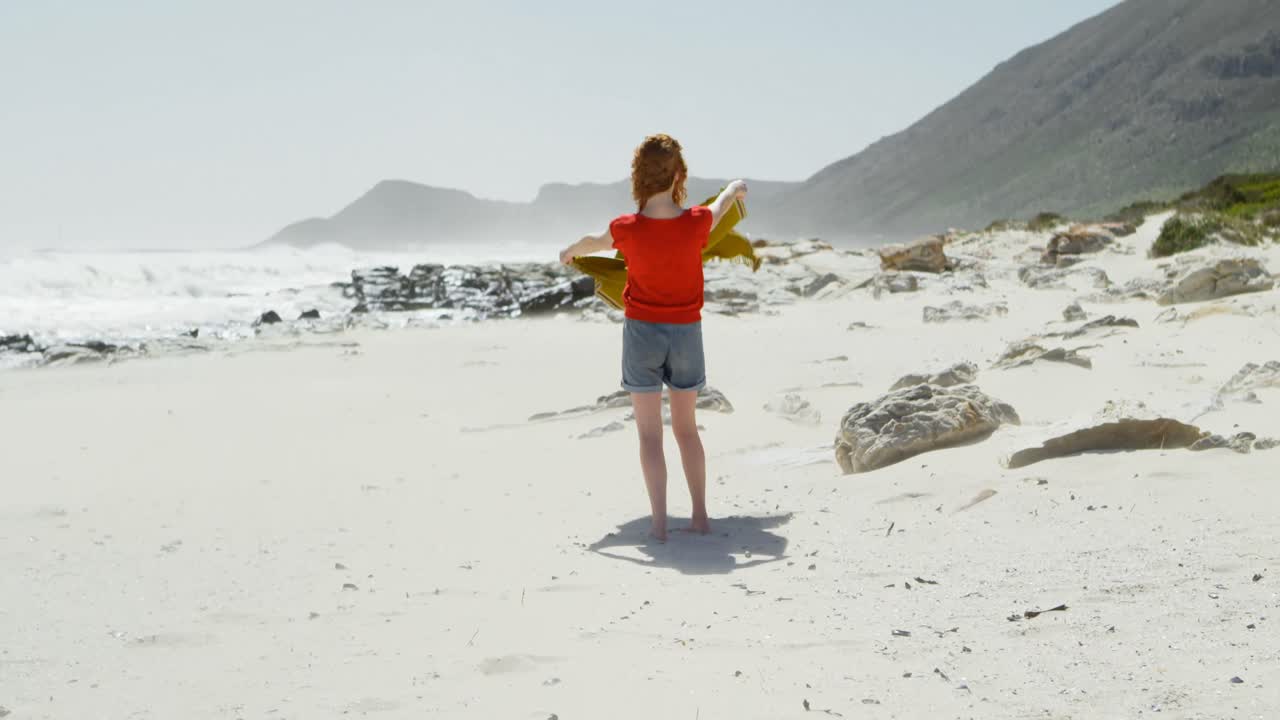 Carefree woman holding shawl against the breeze 4k
