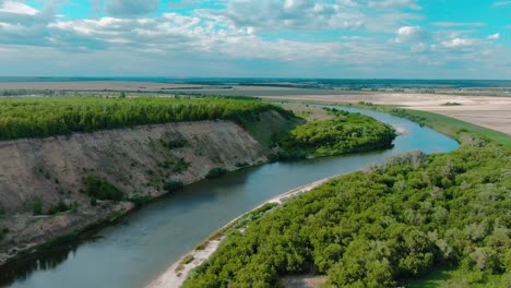 aerial view of a river winding through a lush green valley