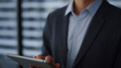 Businessman-reading-financial-report-on-tablet.-Male-employee-browsing-internet