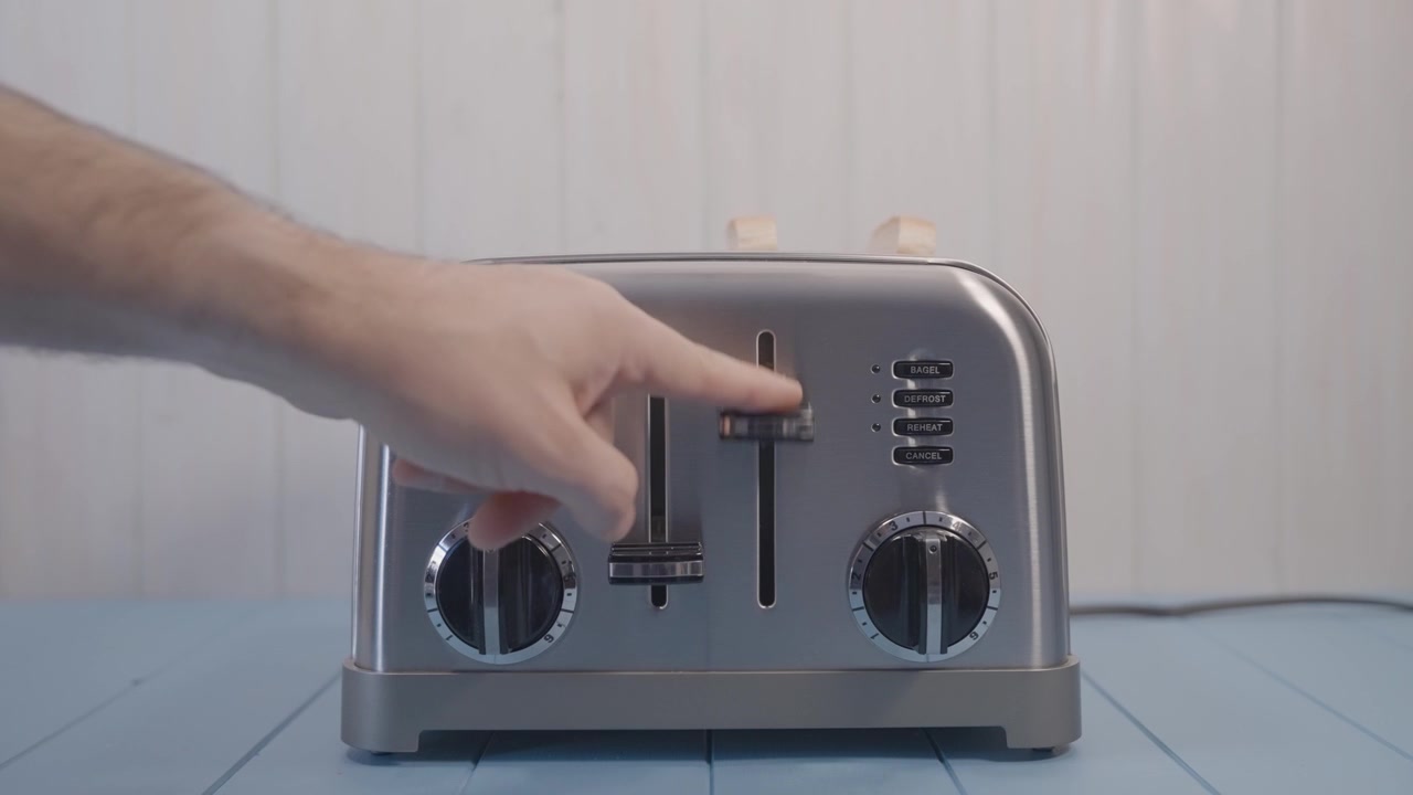 slices of Sandwich Bread incise a Chromed Toaster preparing morning breakfast