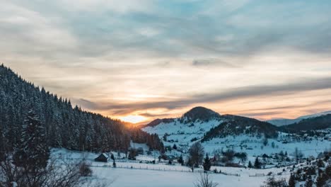 Golden-Sunset-Over-Snowy-Mountains-With-Dense-Coniferous-Forest-During-Winter