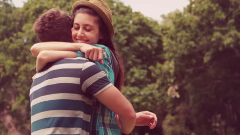 in slow motion young couple hugging in the park