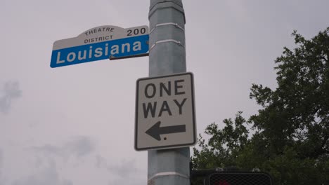 Low-angle-view-of-Louisiana-Street-sign-in-downtown-Houston,-Texas