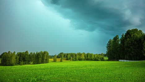 Dark-clouds-blowing-over-a-lush-green-countryside-landscape---time-lapse