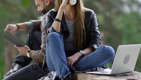 woman drinking coffee on stone bridge