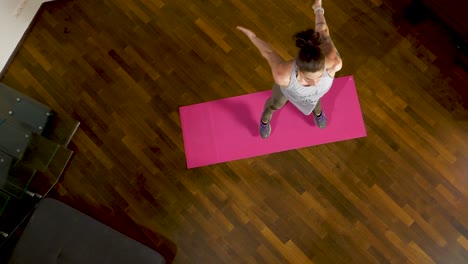 Jumping-up-and-down-while-doing-squat-jumps-to-strengthen-her-legs-and-improving-her-coordination-skills