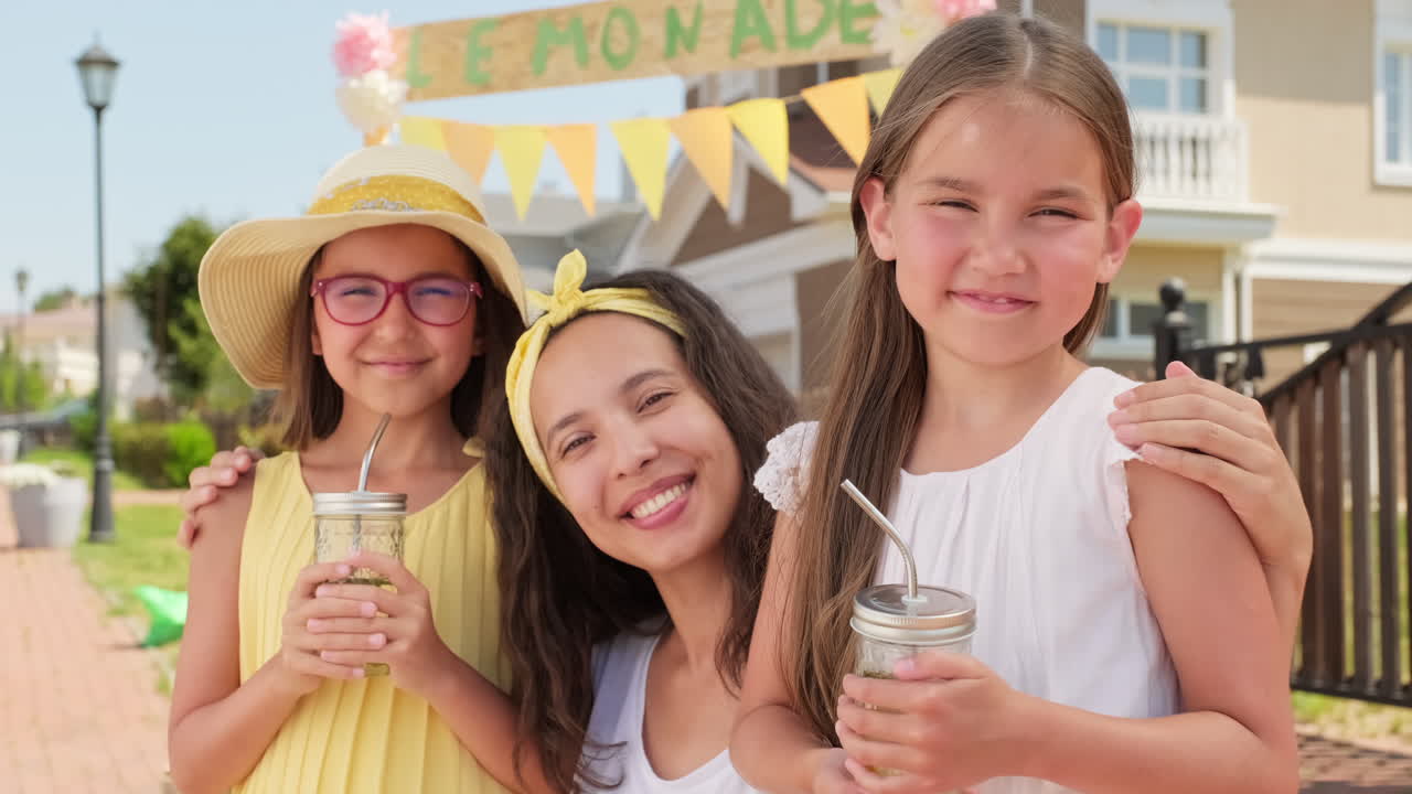 Portrait Of Mom With Daughters On Summer Day
