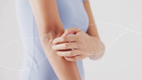 animation of dna strand over african american woman scratching her arm
