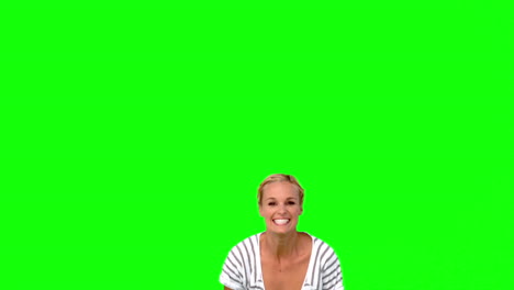 blonde woman jumping against green screen