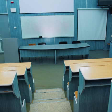 empty auditorium. modern lecture hall in the university. wooden desks in front of blackboard and multimedia board in conference hall