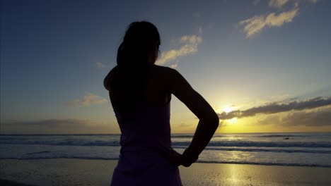 asian girl with sport watch exercising on sand