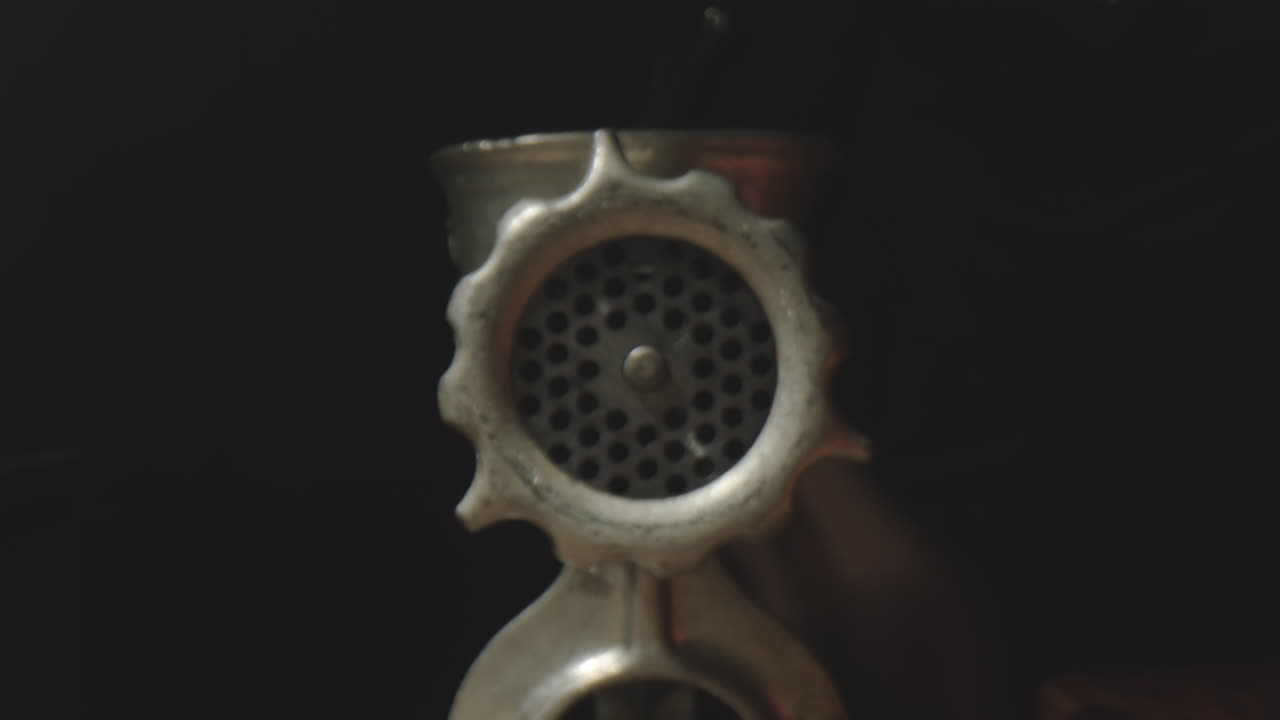 Chef Operating Meat Grinder