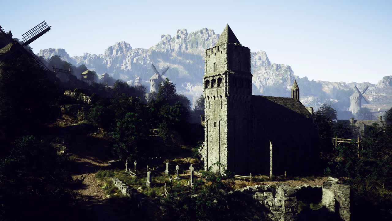 Medieval church stands on hillside with windmills and mountains in background
