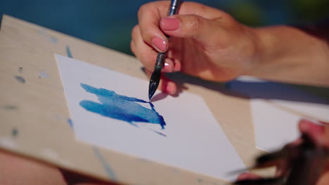 woman painting with watercolors